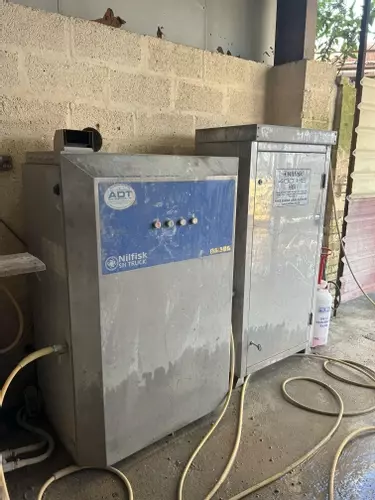 Nilfisk SH Truck Booster and DTE 500 HS pressure washer system before servicing, showing dirt build-up and signs of heavy use prior to a full service and performance restoration.